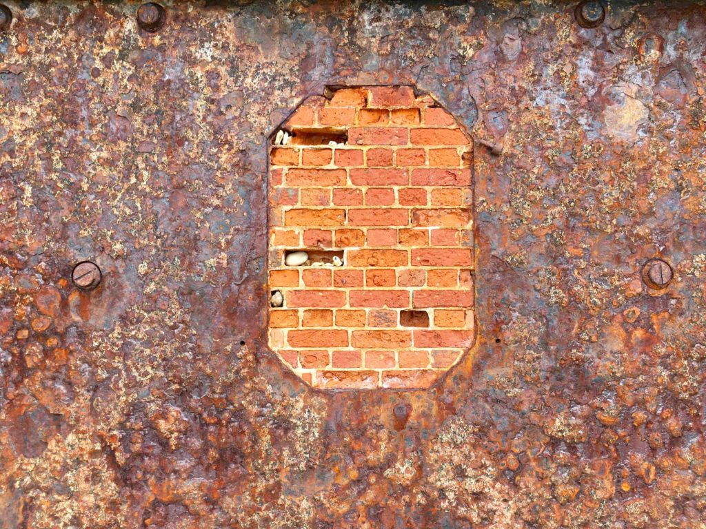 One of the original Hurst Castle iron and teak blast plates, with the old gun port bricked up