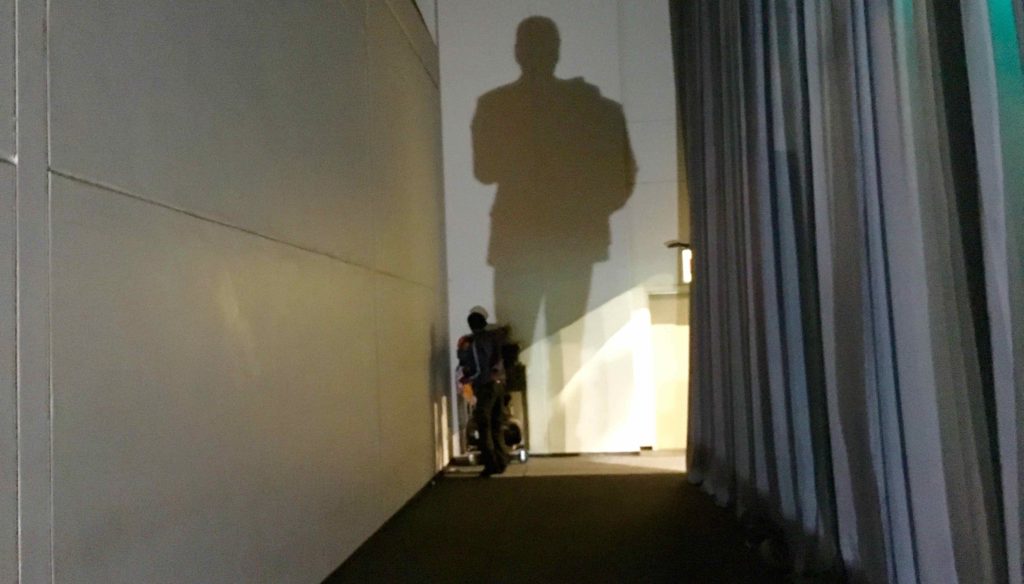 My shadow as I walk behind the curtains